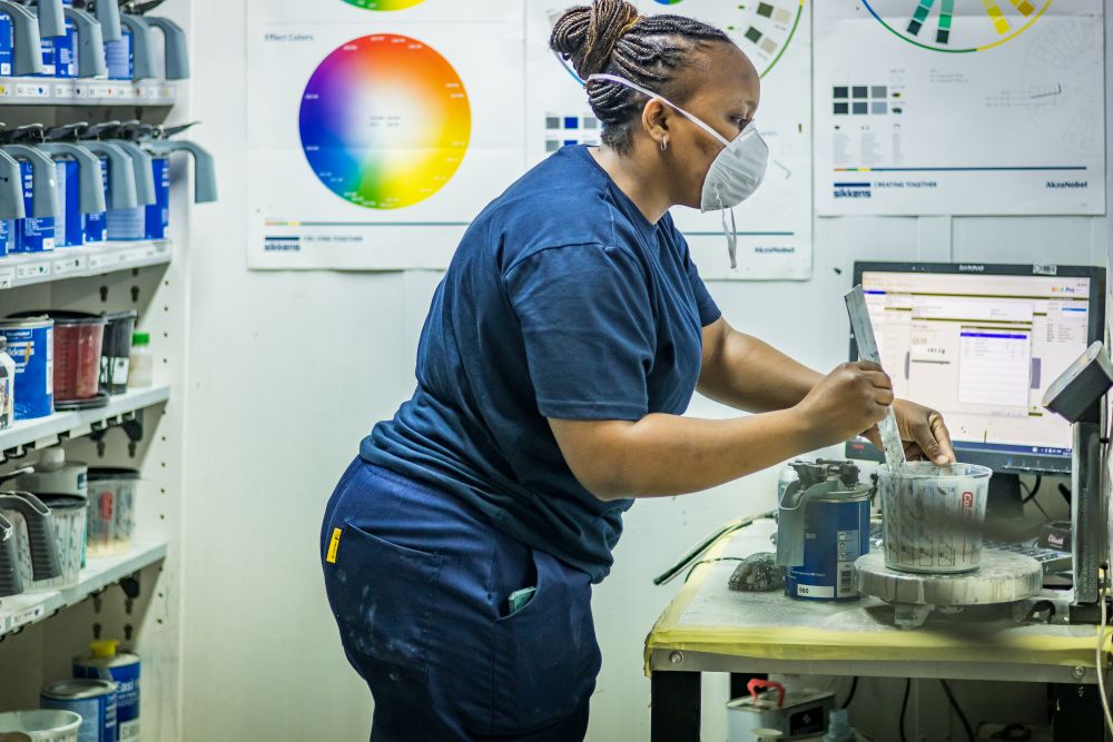 Woman working with paint mixing